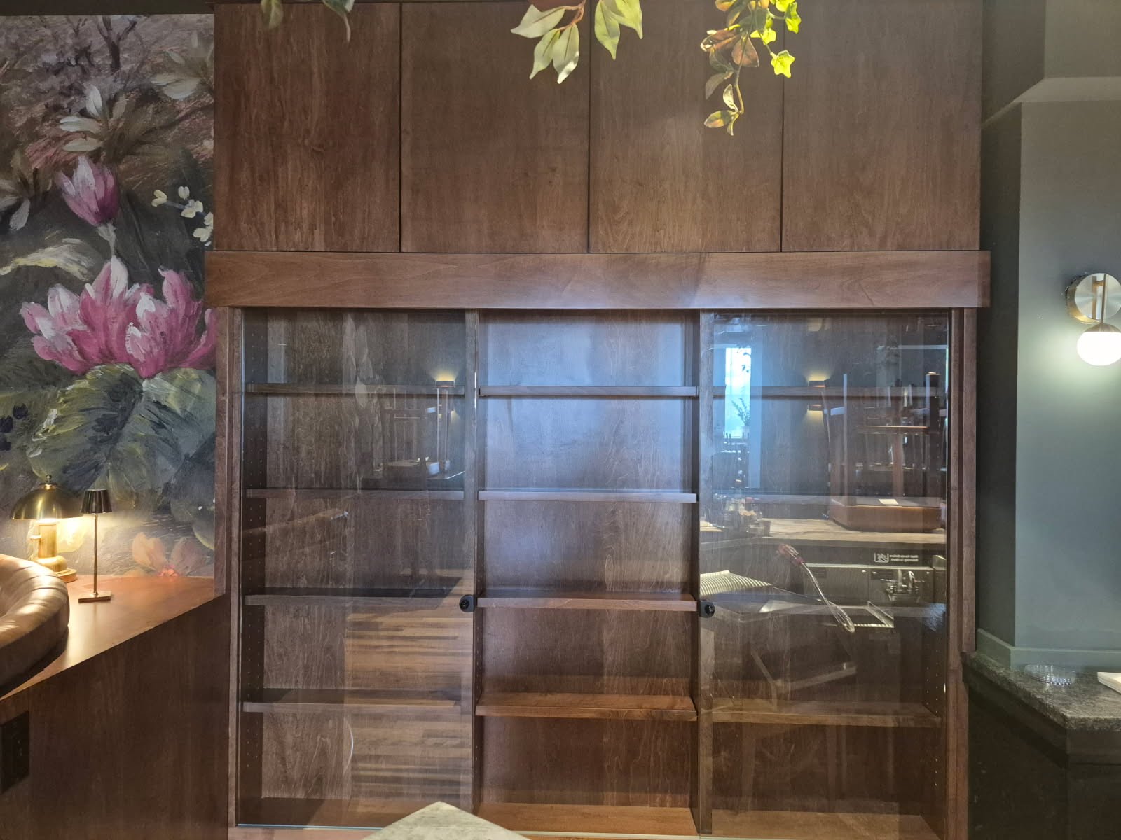 Custom walnut cabinet with sliding glass doors and open display shelving built for Abode restaurant