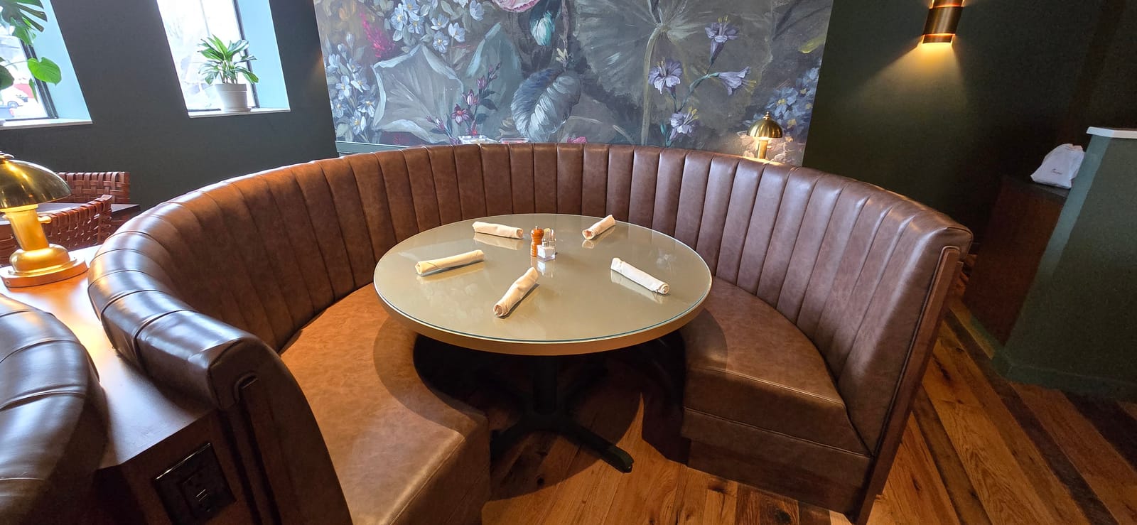 Circular radius booth with glass-top table